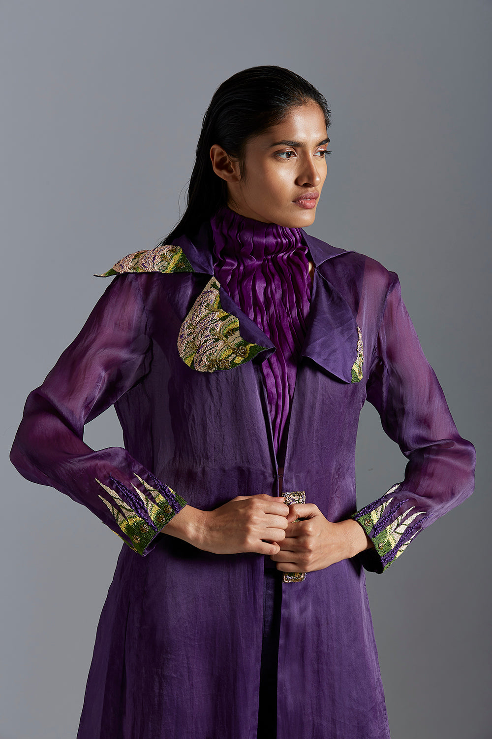 Close-up of the French knot embroidery on the carpet long jacket, highlighting the intricate design and elegant details