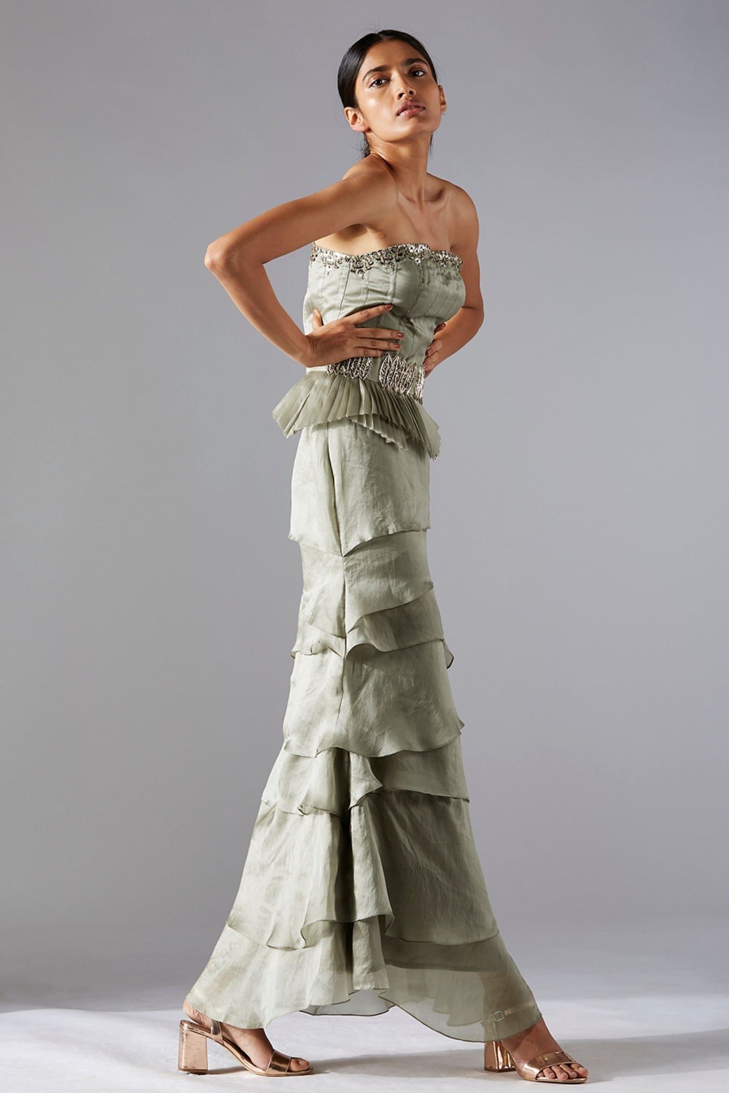 Side view of the corset and skirt set, showcasing the strapless gown and cascading pleated skirt
