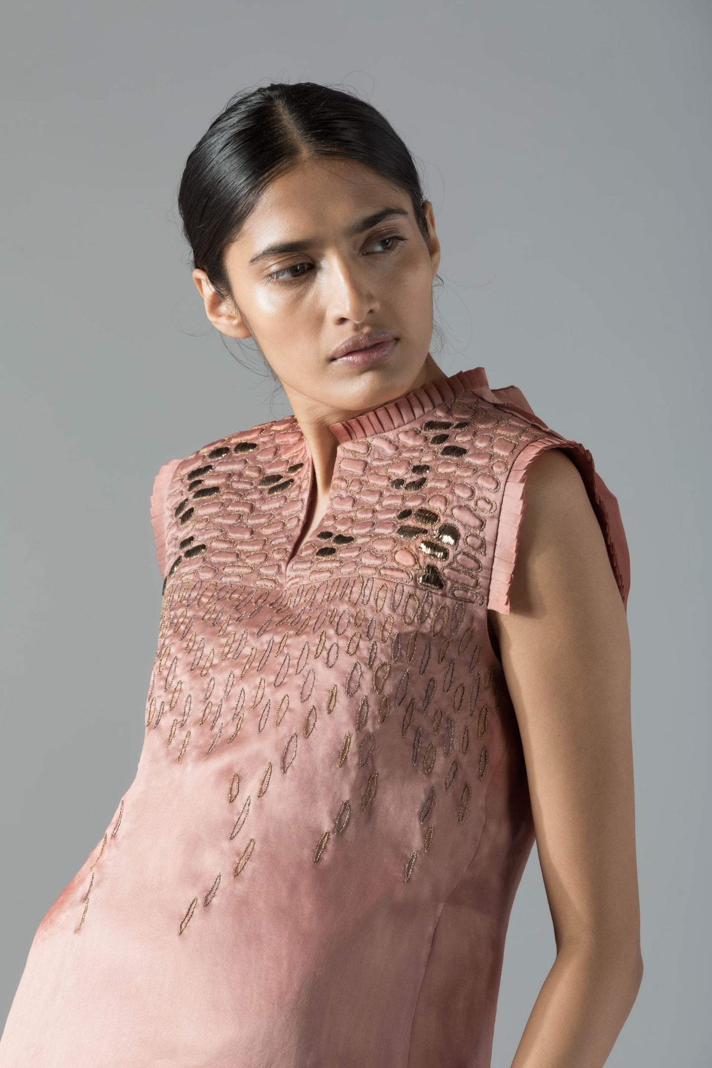 Close-up of the rope detailing and pleats on the luxury designer dress, highlighting intricate design elements