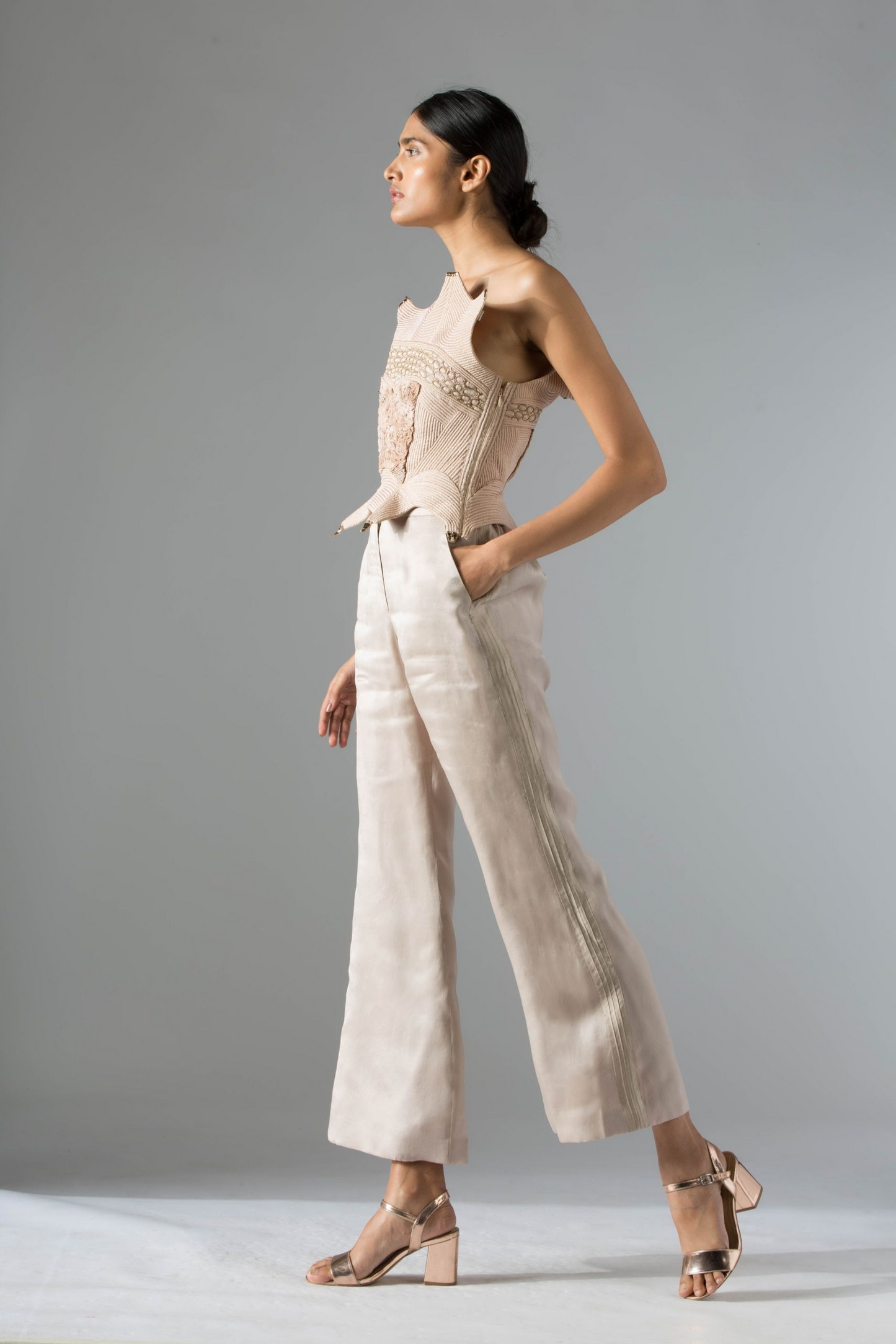 Side profile of the Dune corset top, showcasing its sleek silhouette and the elegant inlaid dori and mukaish embroidery