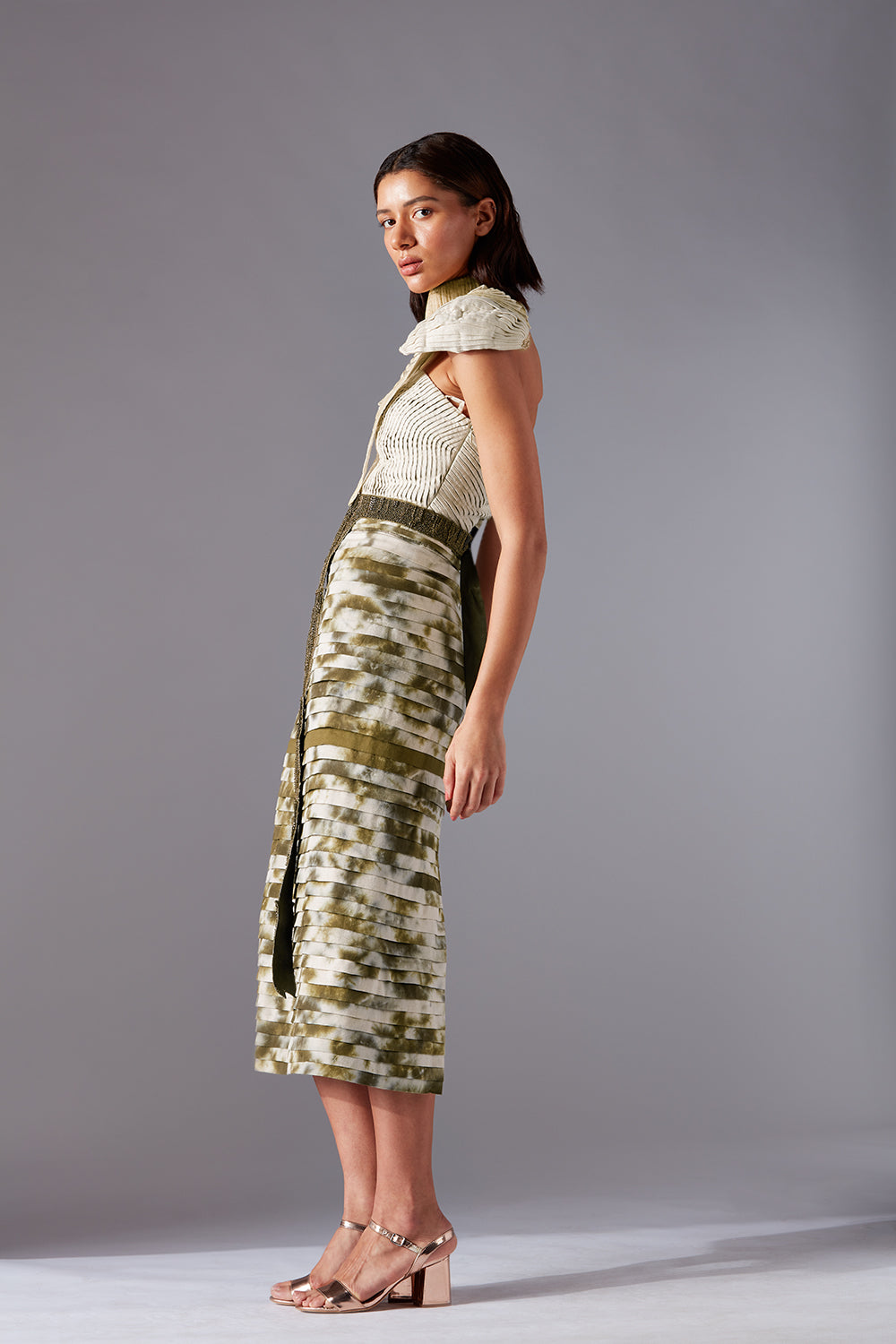 Side view of corset skirt set with intricate beaded detailing and hand-painted sash