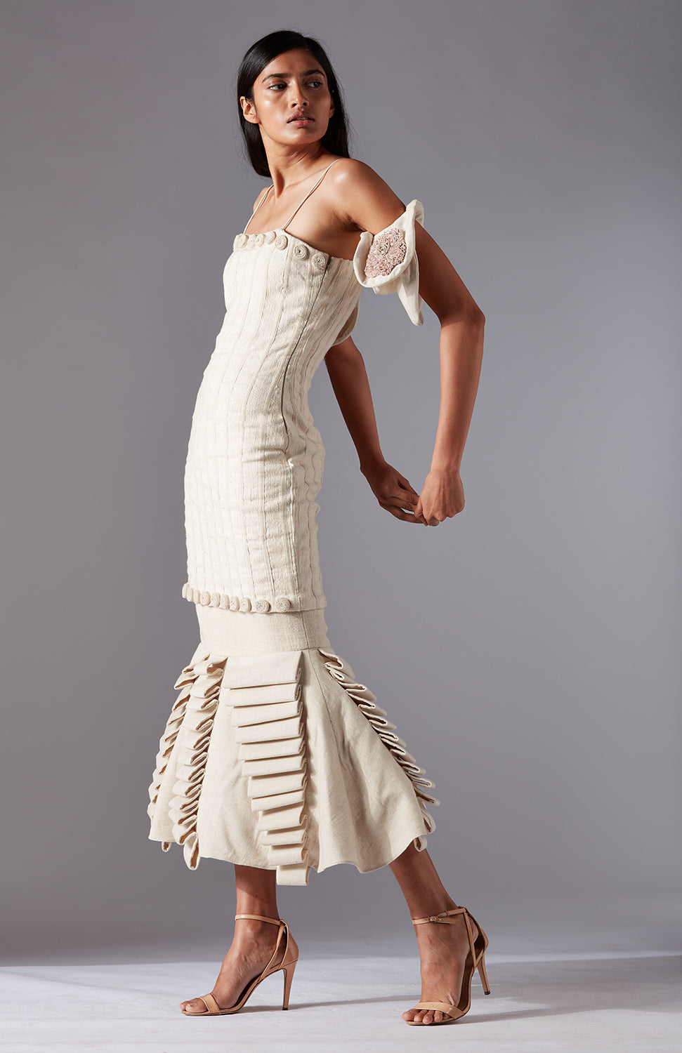 Side view of the Wood Crust Chimes couture dress in khadi, emphasizing the elegant lamp silhouette