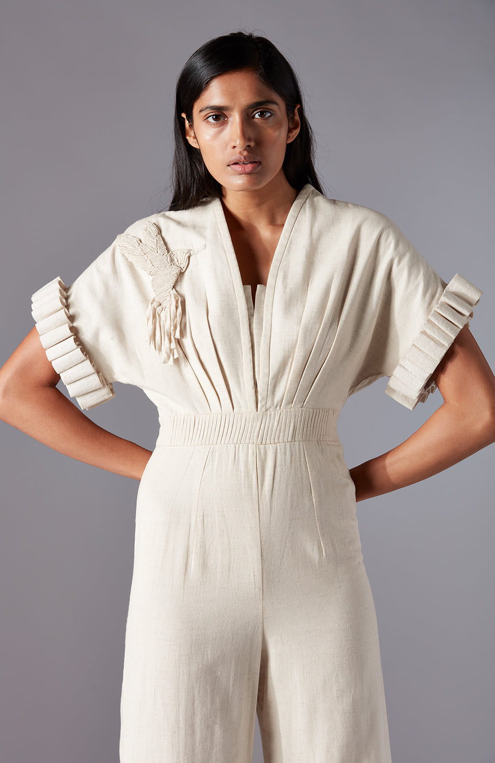 Close-up of the hummingbird motif and sculpted sleeves on the modern khadi jumpsuit for women