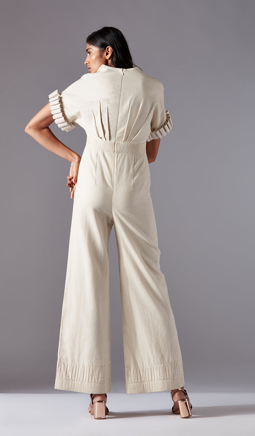 Back view of the stylish modern jumpsuit for women, emphasizing the tailored fit and chic sculpted sleeve details
