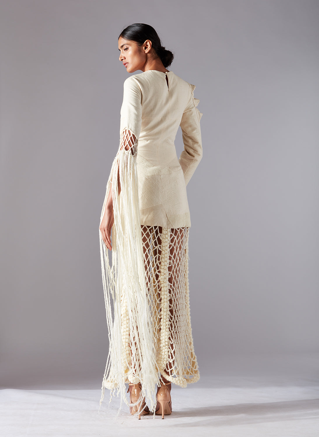 Back view of the Collage Crochet Gown, emphasizing the graceful drape and design details