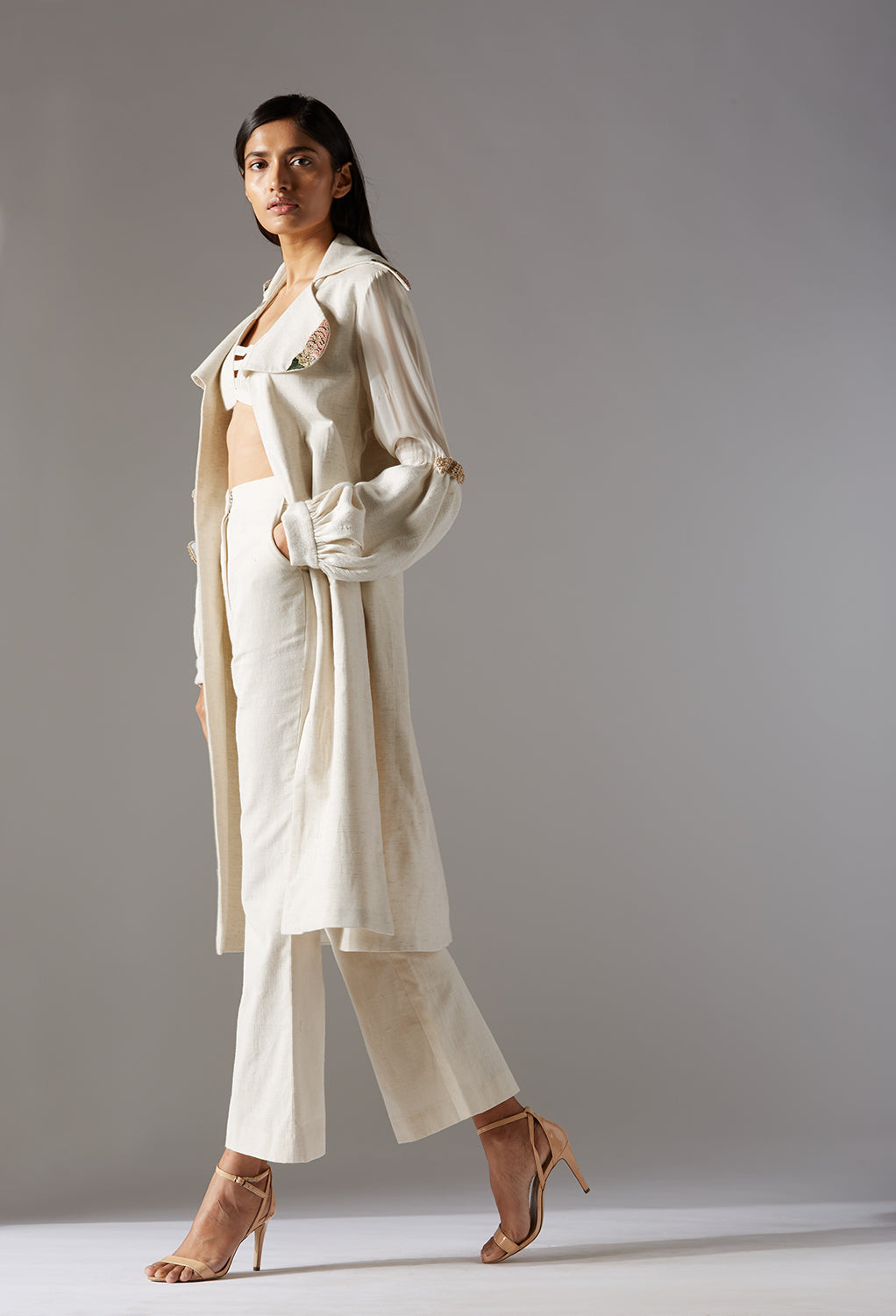 Side view of the coat pant for women, showing the flattering silhouette and chic design paired with the bralette