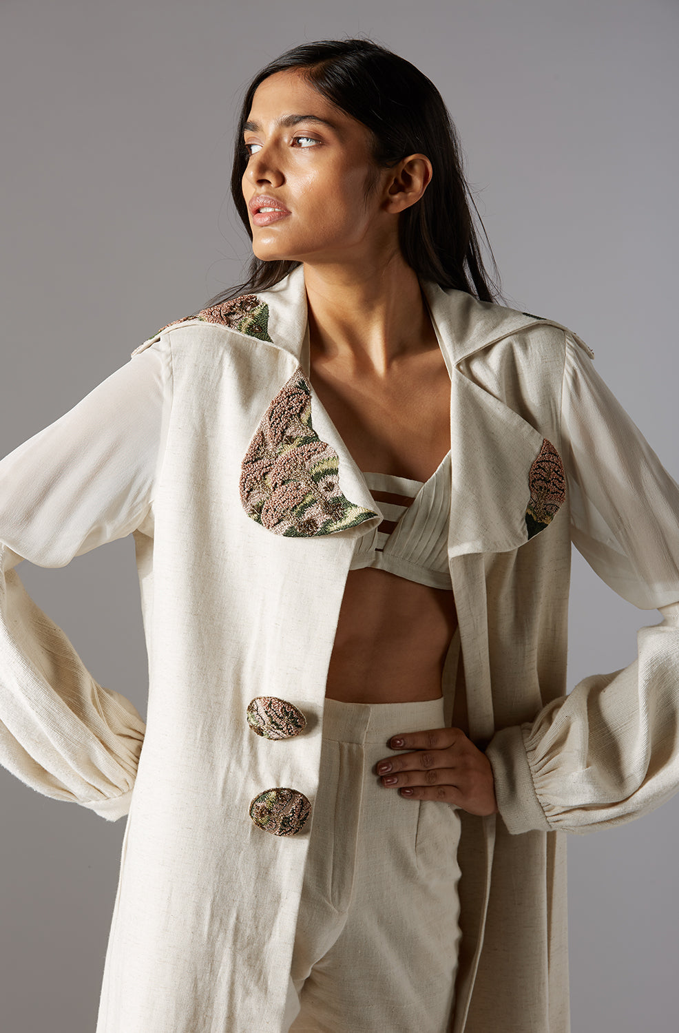 Close-up of the designer bralette paired with the coat pant set, highlighting intricate design details