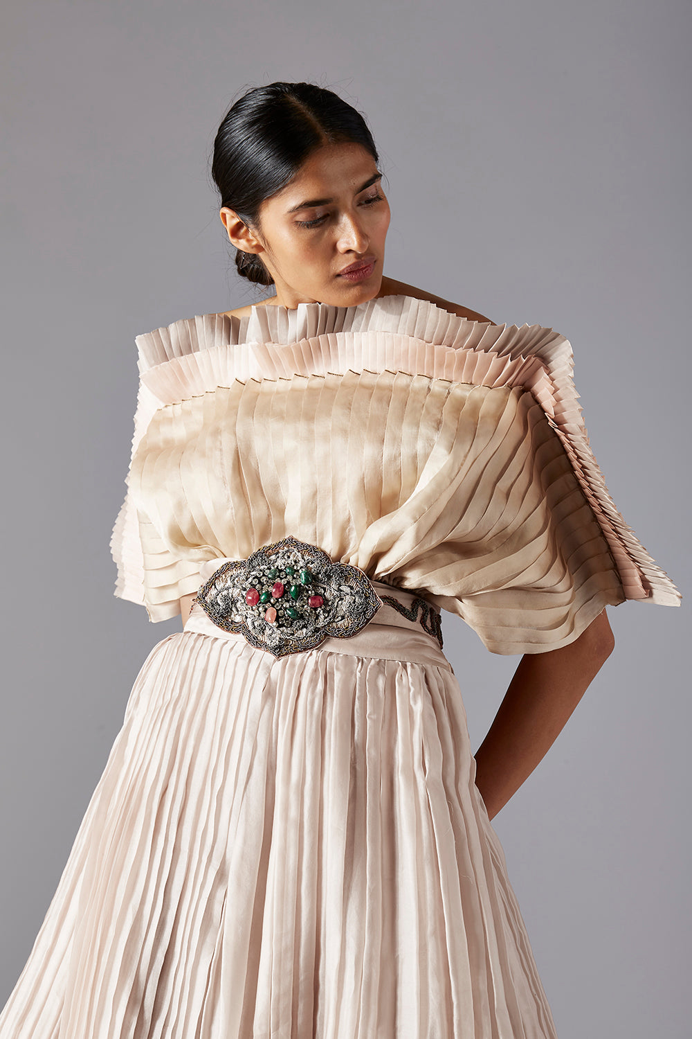 Close-up of the pleated details on the mushroom top and the voluminous design of the ballroom skirt