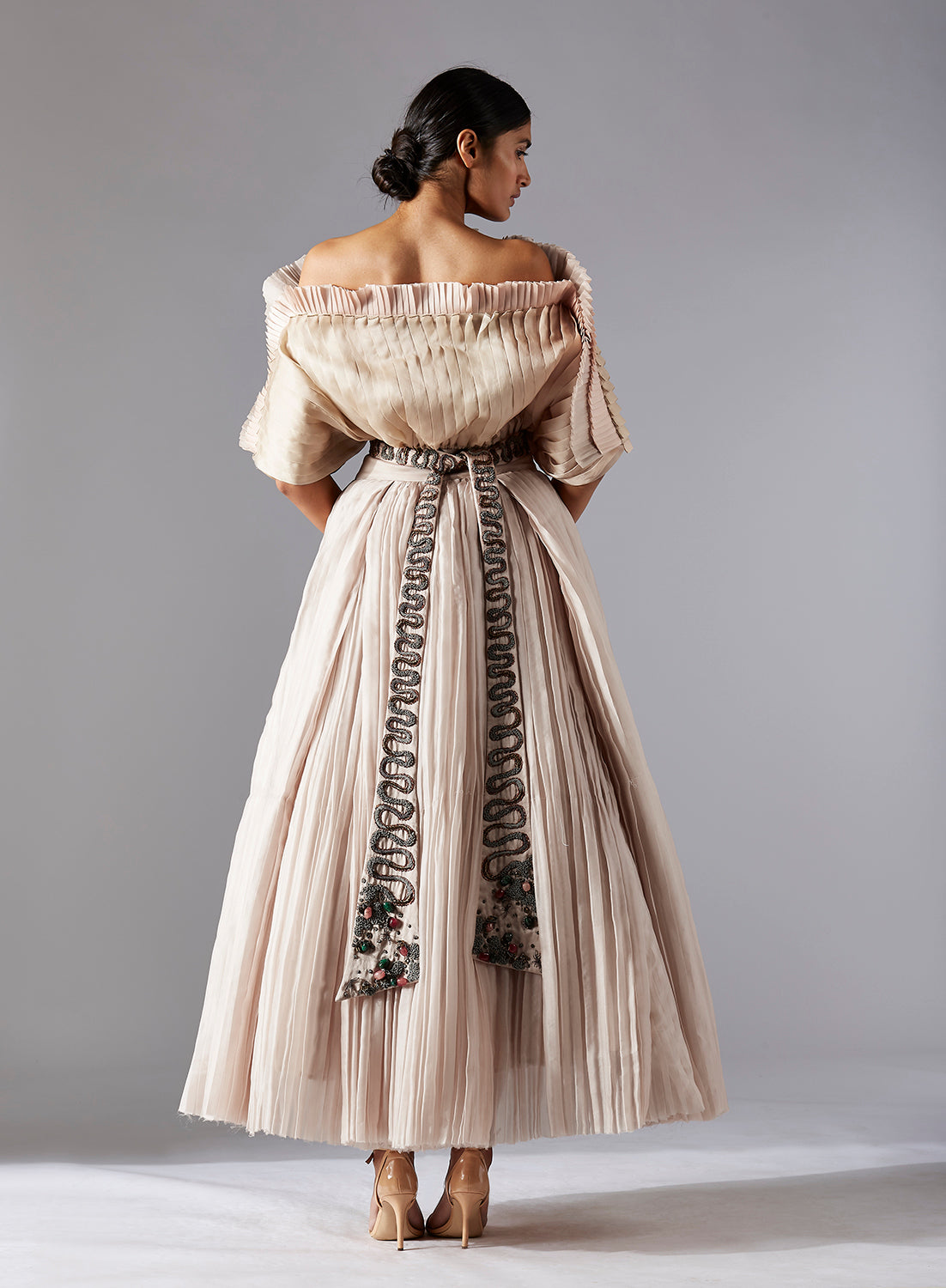 Back view of the avant-garde pleated top and grandeur ballroom skirt, showcasing the unique design and movement