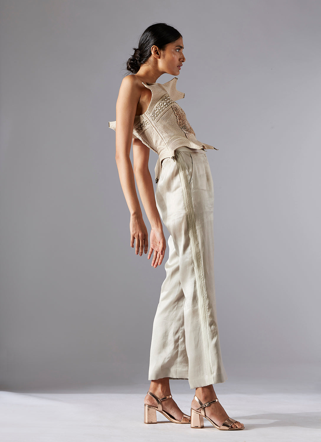Side view of the Dune corset top with inlaid dori work and organza pants, highlighting the modern, sleek silhouette and elegant design