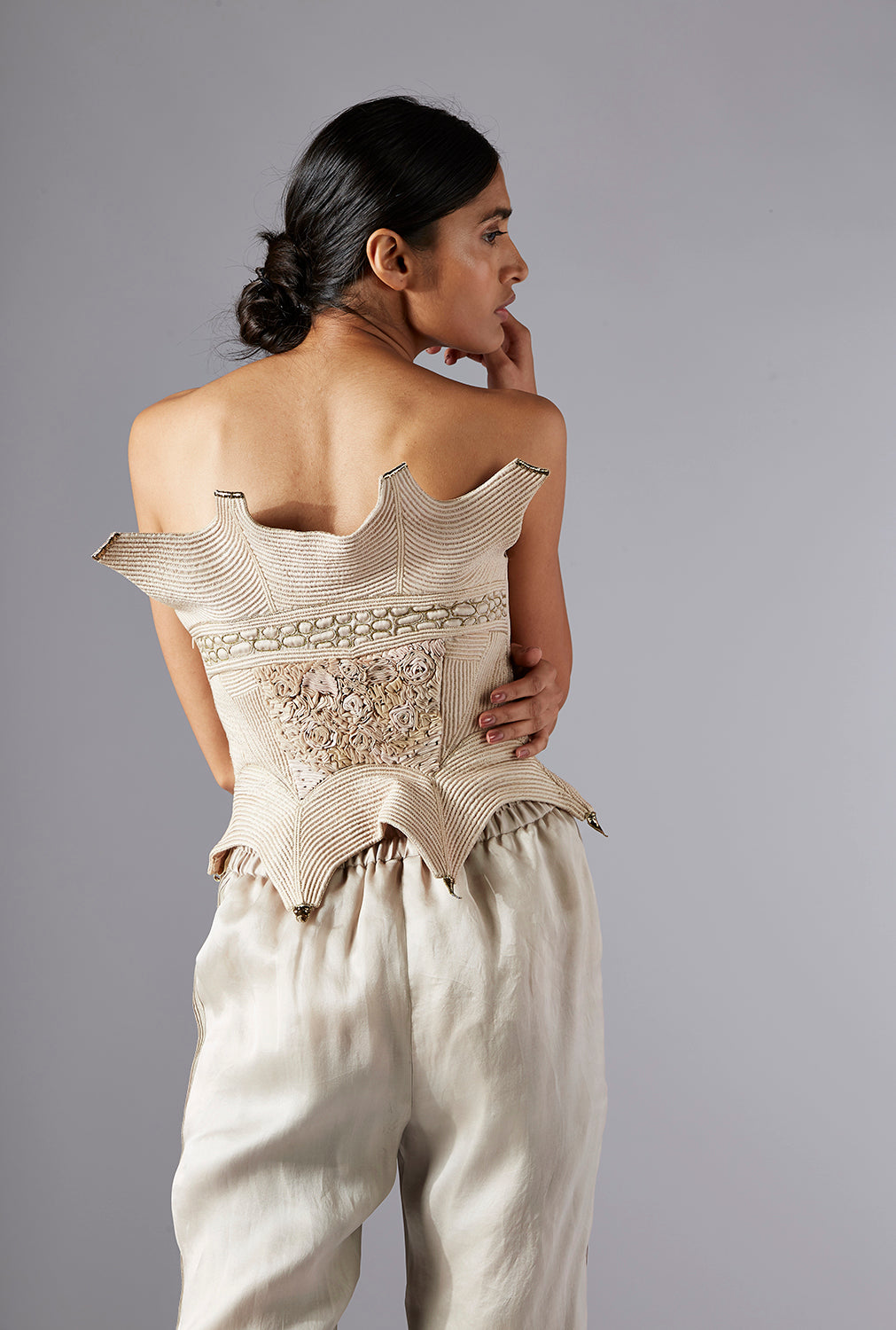 Close-up of the back view of the Dune corset top, showcasing the intricate dori work and seamless fit with organza pants