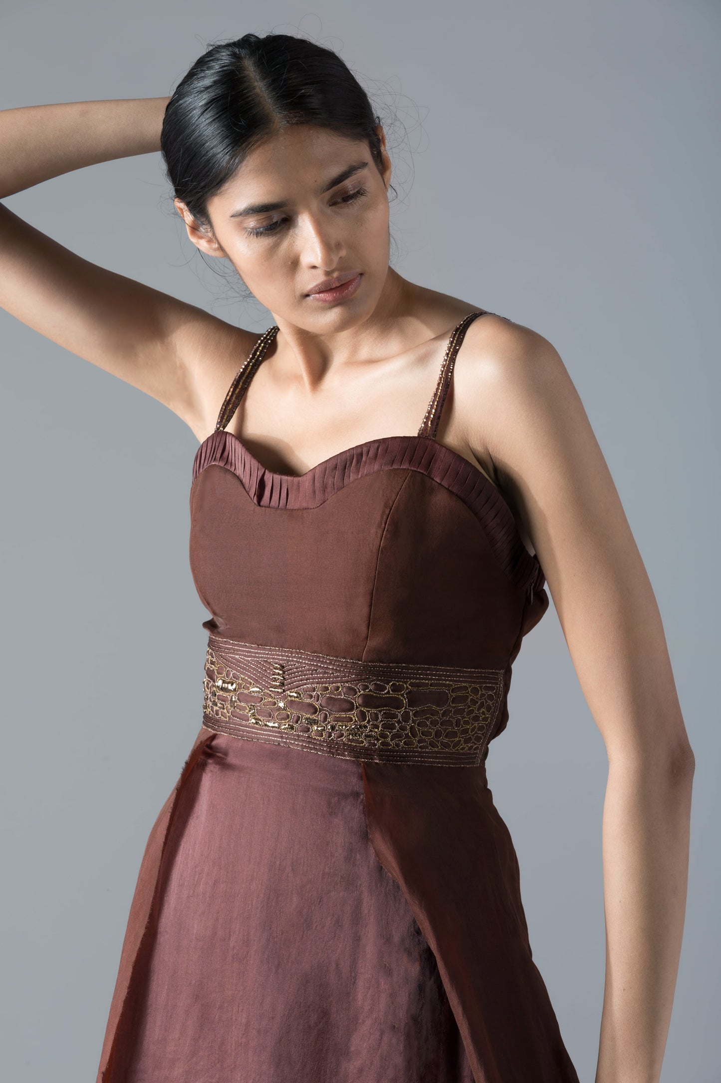 Close-up of the rope inlay and corset detailing on the tea-length designer dress, showcasing intricate craftsmanship