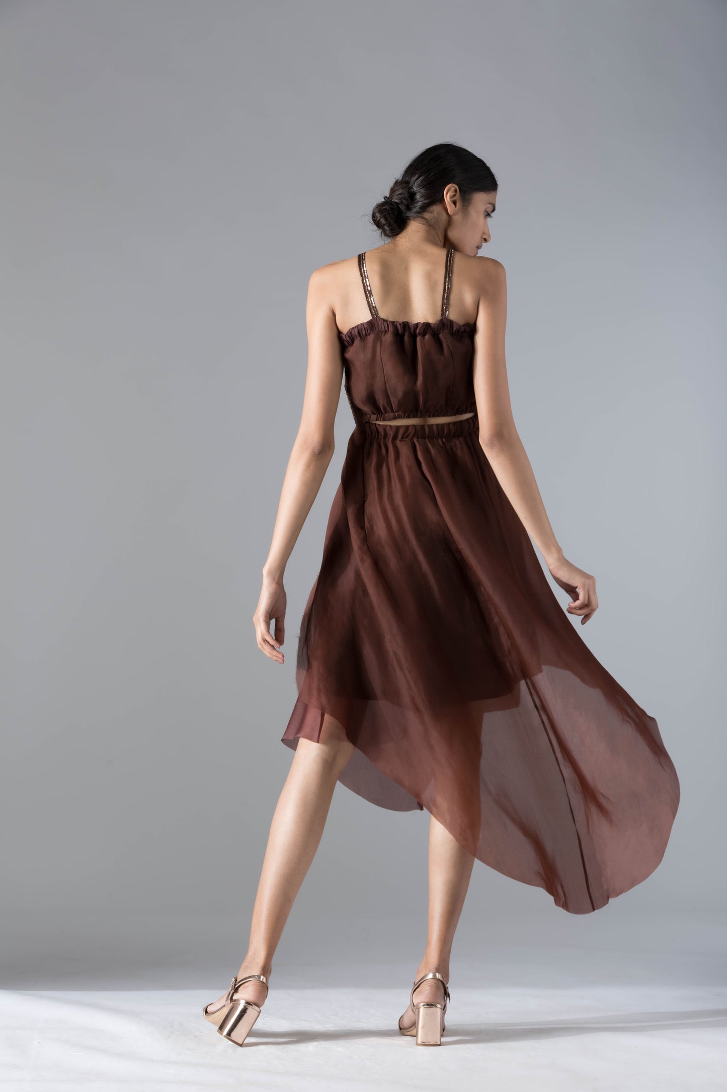 Back view of the luxury designer dress, showcasing the elegant back cut-out and corset details
