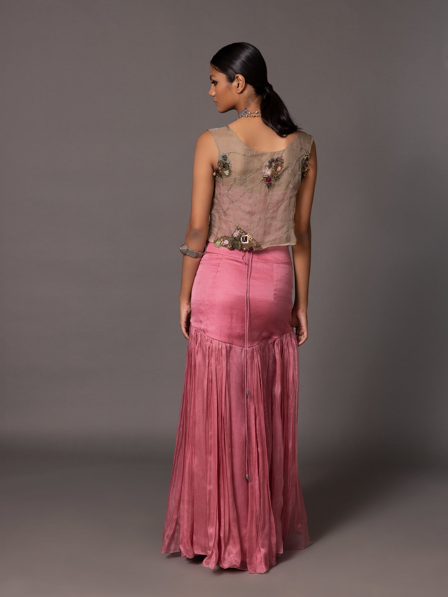 Back view of the Kaner Pink Corset Top & Skirt with embroidered jacket, showcasing the delicate thread work on the gilet