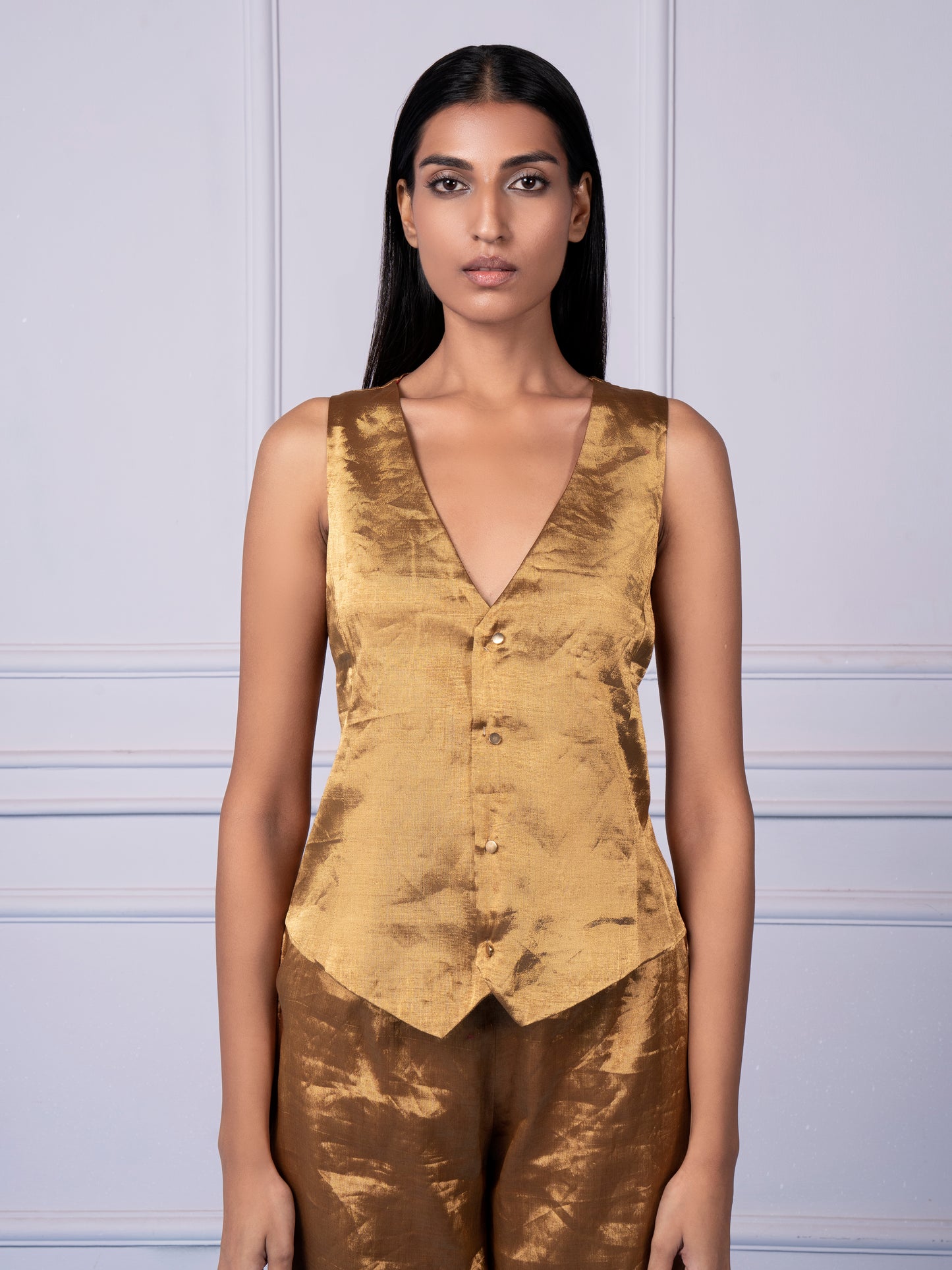 Close-up view of the handwoven texture on the Gold Chanderi waistcoat and the luxurious fabric of the flared pants