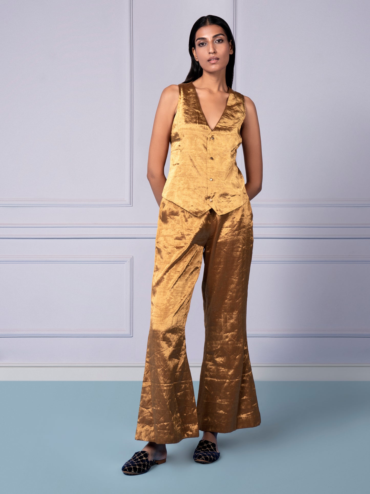 Woman confidently wearing the Gold Chanderi waistcoat and flared luxury pants, perfect for a modern, sophisticated look