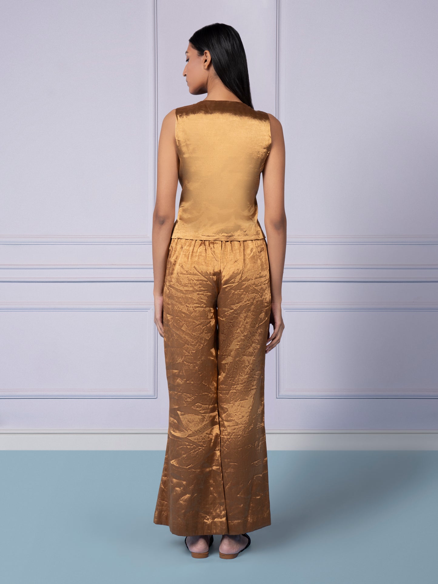 Back view of the Gold Chanderi designer waistcoat and flared pants, emphasizing the tailored and luxurious design
