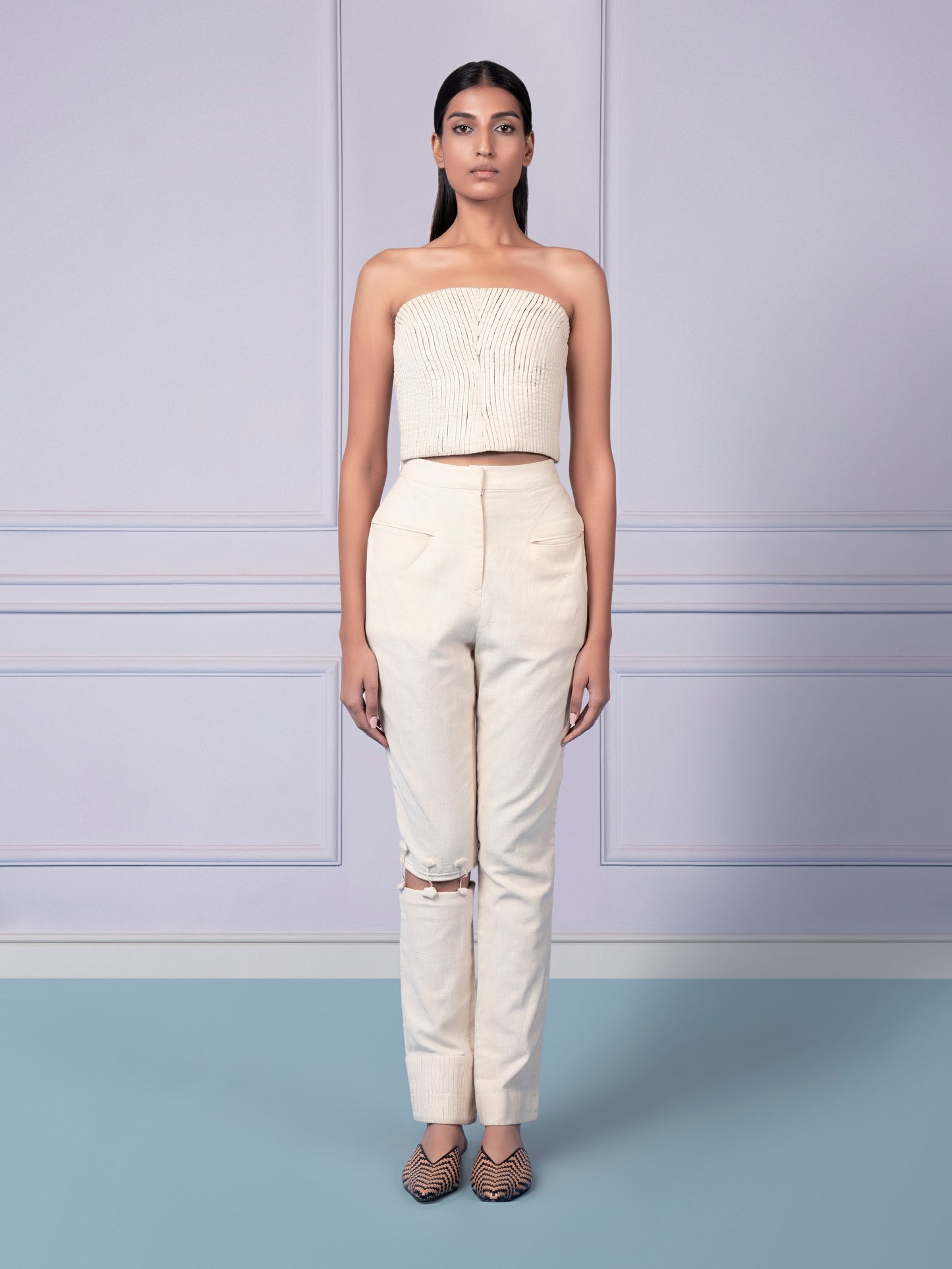 Modern khaadi corset top with strake pattern paired with narrow pants featuring cutout knee detailing for a stylish, fashion-forward look