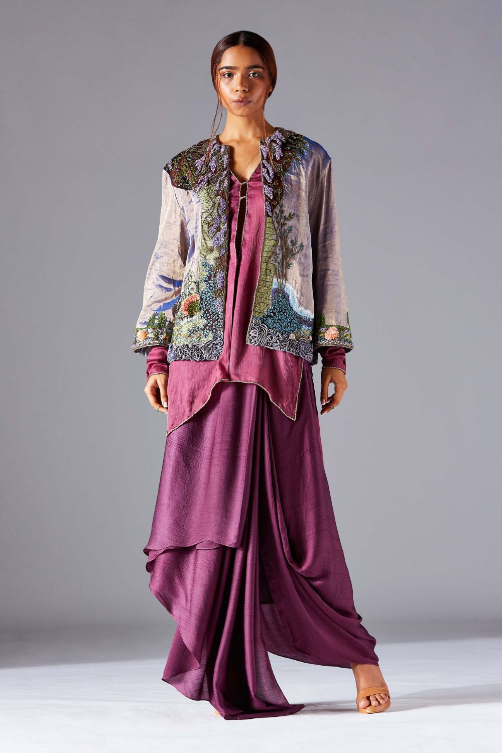 Embroidered jacket with Jacobean handwork, paired with a pleated dhoti-style lungi and kurta set for women, showcasing a stylish modern outfit
