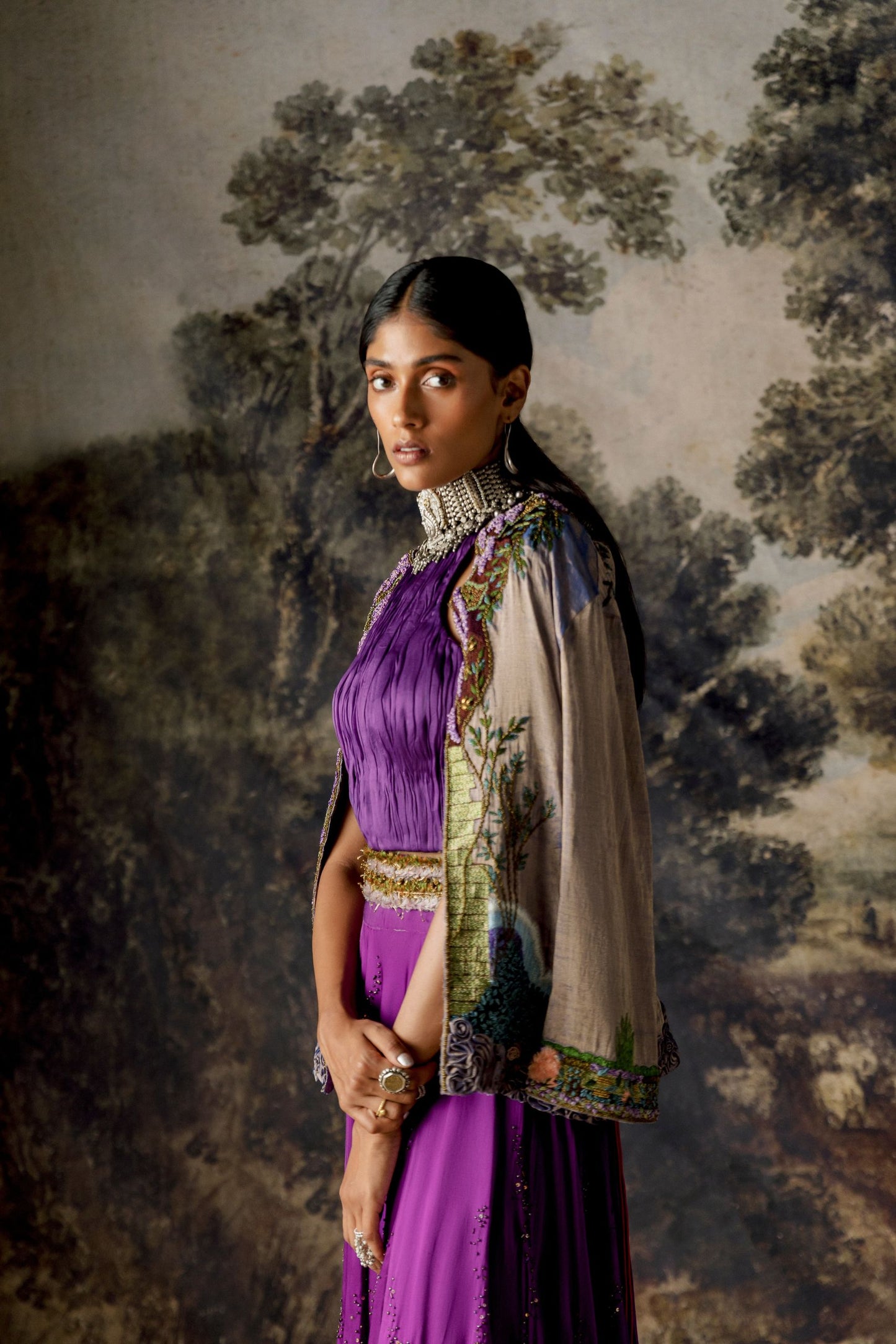 Model wearing the Elysian Iris Lehenga Set with a hand-embroidered jacket, ruched top, and two-tier skirt for a sophisticated look