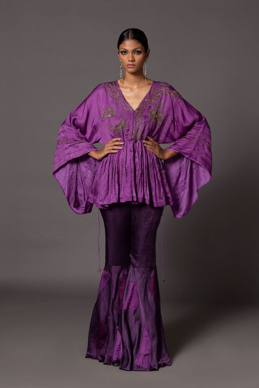 Purple Shikhar Baugh peplum top with contemporary metallic Jaipur motifs, paired with fit-and-flare gharara pants featuring color-blocked patchwork from A Humming Way