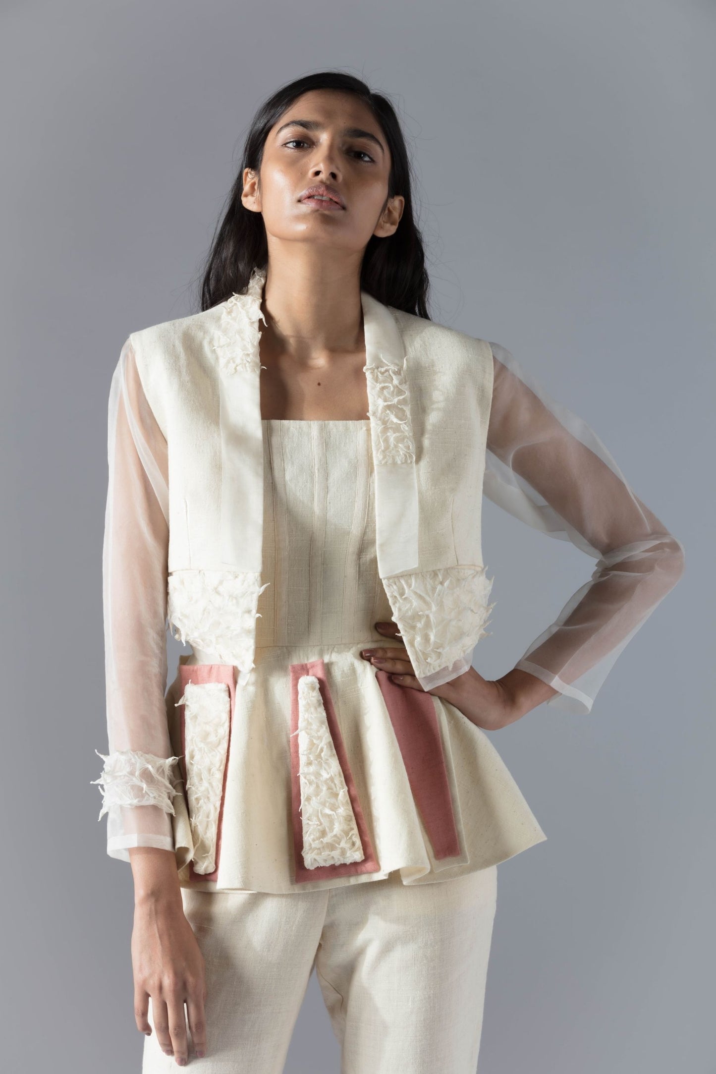 Close-up of the peplum top with unique detailing and the jacket pant set in organic khadi fabric