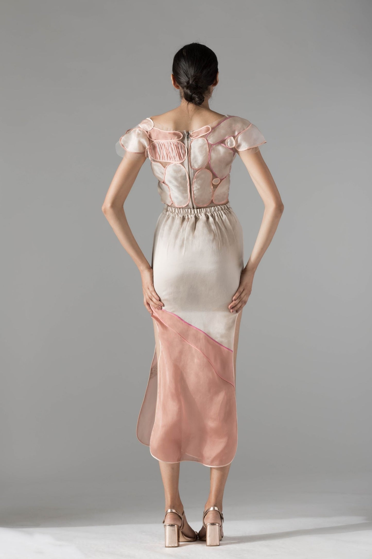 Back view of the stone top and panelled skirt set, showcasing the comfortable elasticated waist and stylish cut